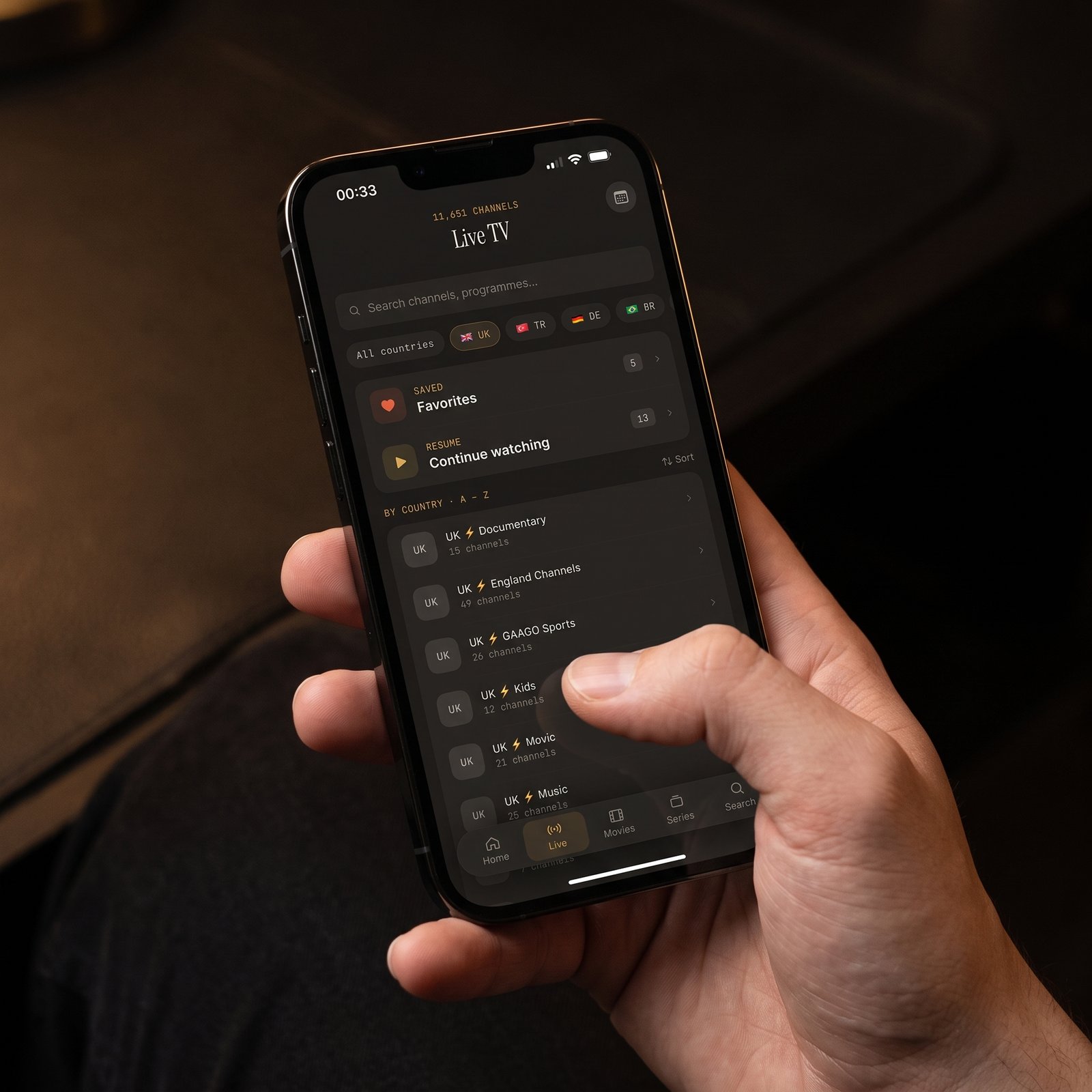 Maximus IPTV Player Live TV screen on iPhone with country filters, Favorites and Continue Watching